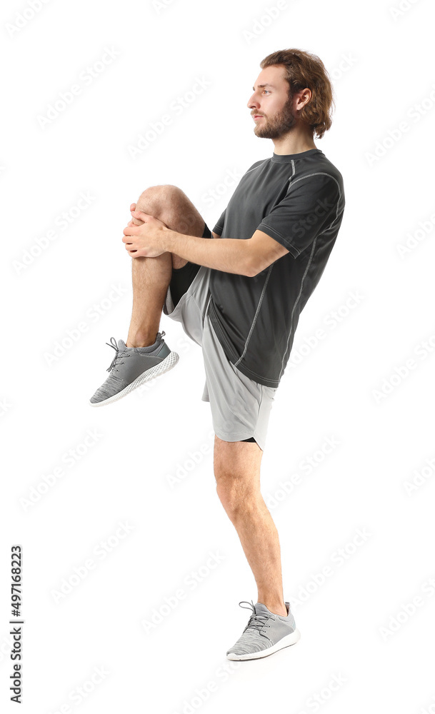 Sporty man stretching on white background