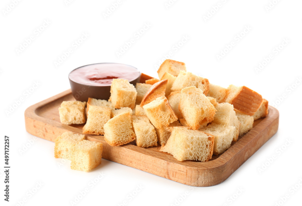 Board with crunchy croutons and sauce isolated on white