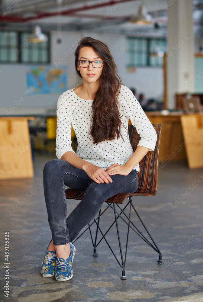 Ive my eyes on success. Portrait of an attractive young woman sitting in an office.