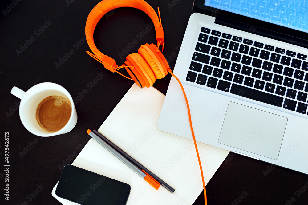 Welcome to the world of modern business. High angle shot of an empty workspace with a laptop, earpho