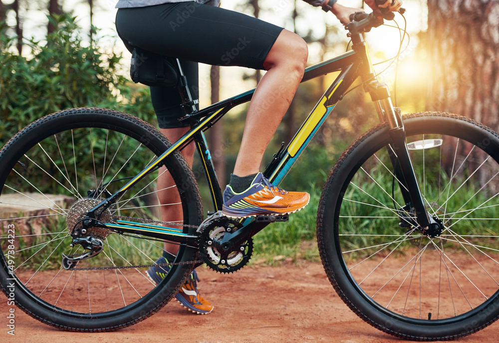 Dominating the trails. Shot of a female mountain biker out for an early morning ride.