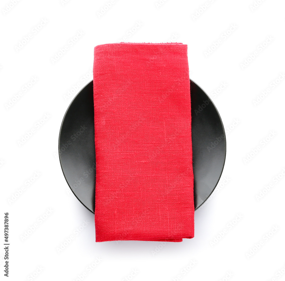 Plate with napkin on white background