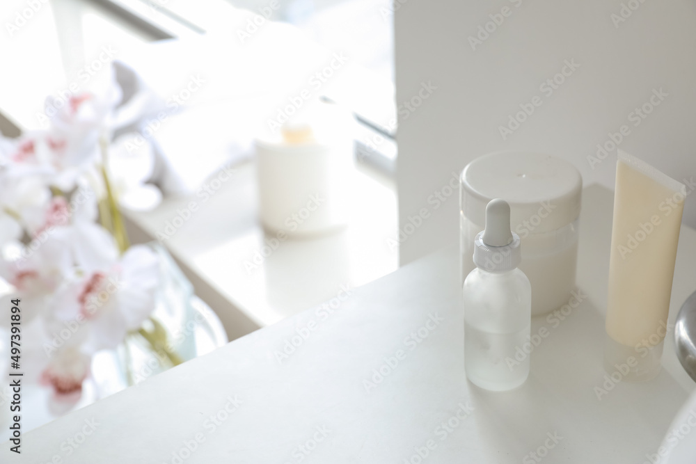 Cosmetic products on shelf in bathroom, closeup