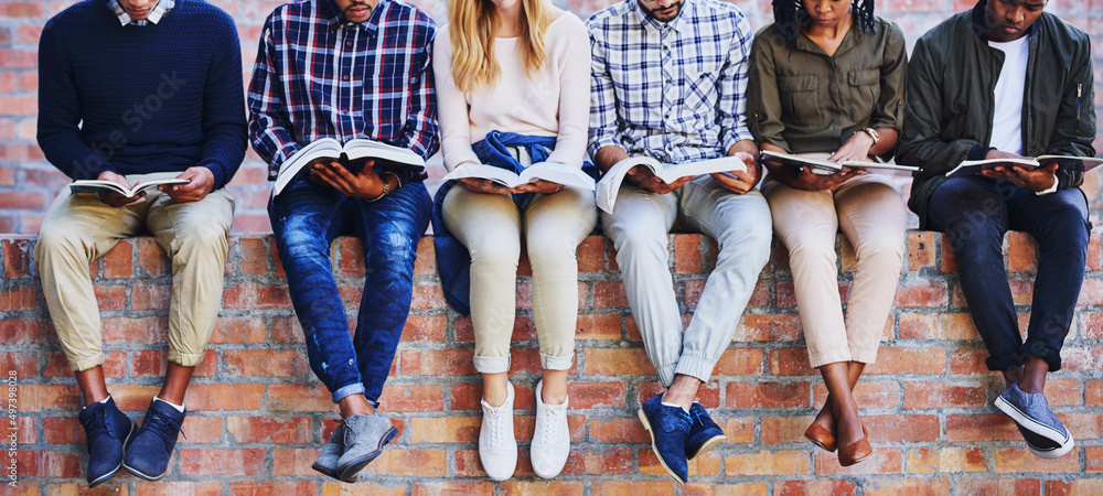 Studying on campus. Cropped shot of a group of unrecognizable university students studying while sit