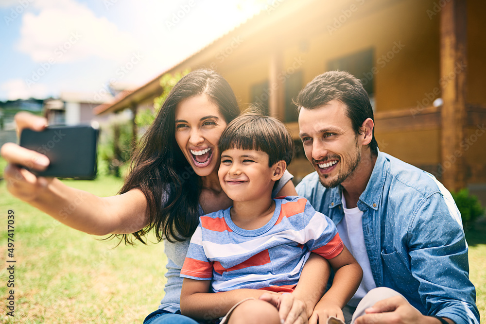 These ones are for the photo album. Cropped shot of a happy young family of three taking selfies whi