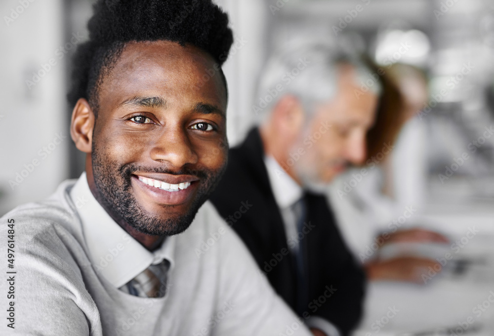 The right time is now. Portrait of a businessman sitting in a boardroom meeting with colleagues blur