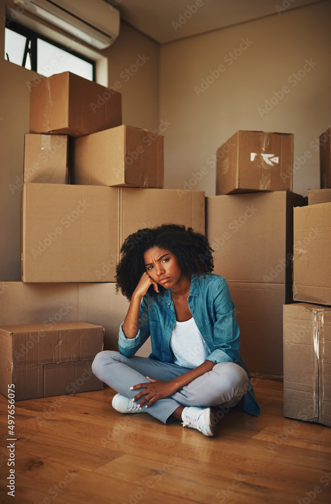 Can someone help me. Portrait of a unhappy looking young woman seated on the ground while being surr