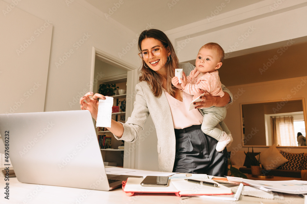 Happy working mom holding a fabric swatch during a video call