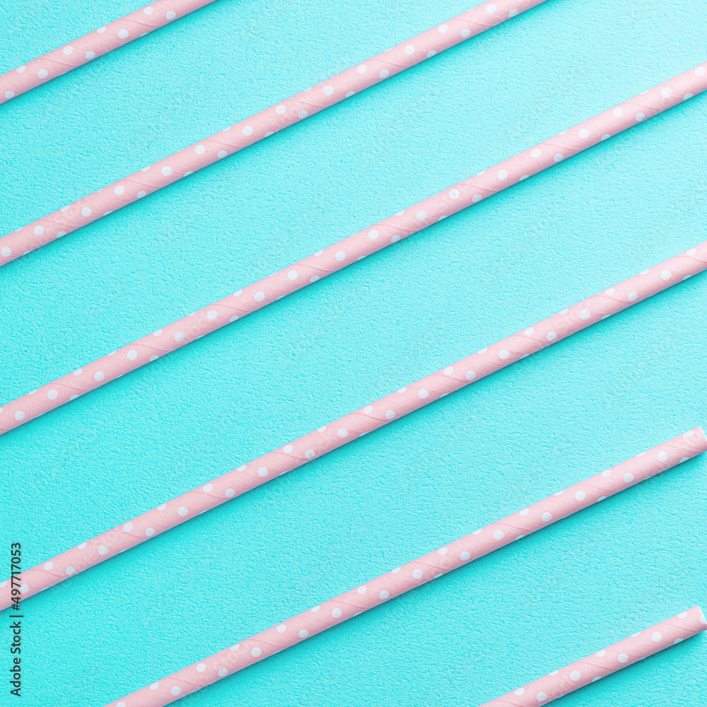 Biodegradable paper straw set on blue table background.