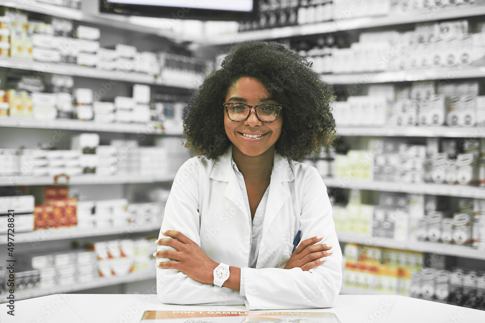 Whats on the menu today. Portrait of a cheerful young female pharmacist standing with arms folded wh