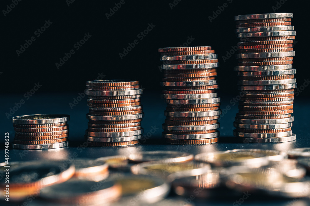 Pile of gold coins stack in finance treasury deposit bank account for saving . Concept of corporate 