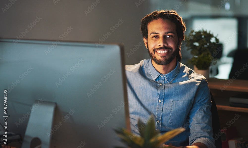 Its all about perseverance and positive thinking. Portrait of a young designer working late in an of