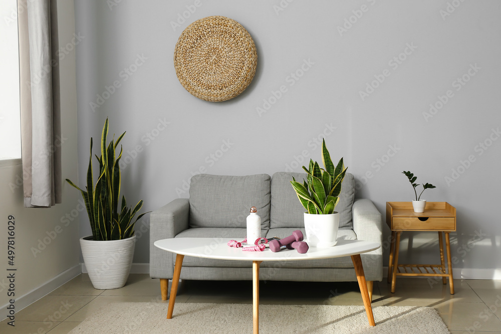 Interior of living room with table and sport equipment