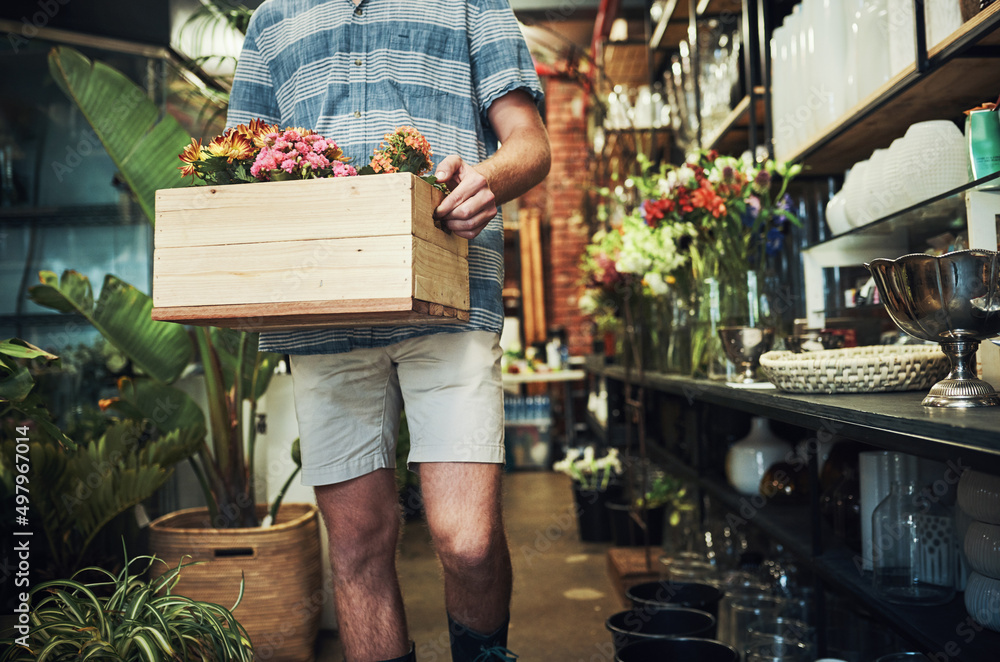 Fresh and wonderful flowers coming right up. Cropped shot of an unrecognizable florist holding a cra