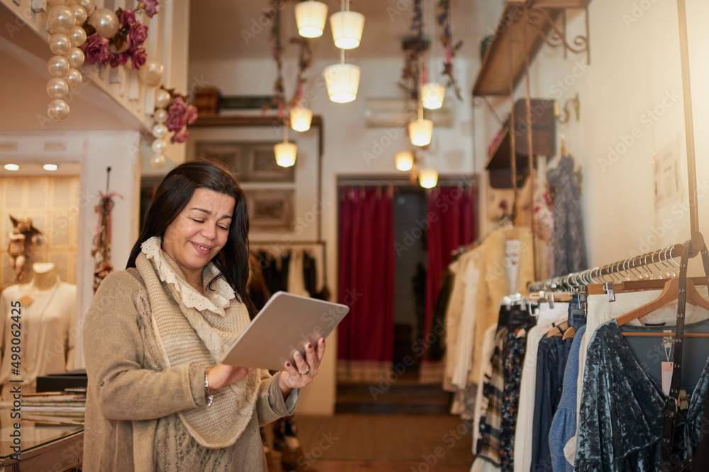 Technology is a business best friend. Cropped shot of an attractive mature female entrepreneur worki