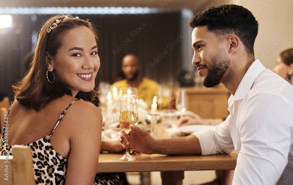 How did I get so lucky. Shot of an attractive young woman sitting with her boyfriend during a New Ye