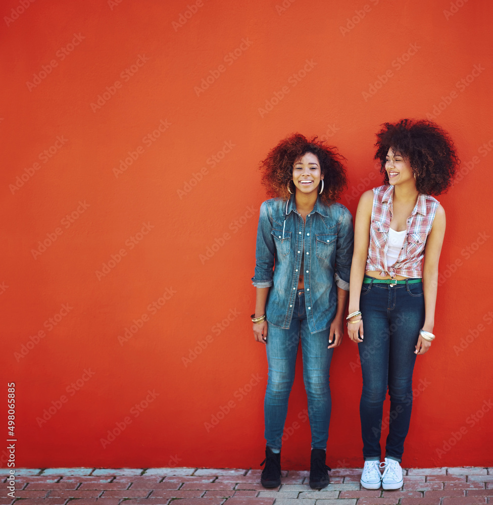 So glad I have her in my life. Shot of two young friends posing in front of a red wall.