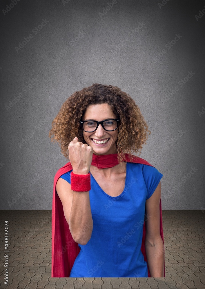 Portrait of african american woman is superhero costume against copy space on grey background