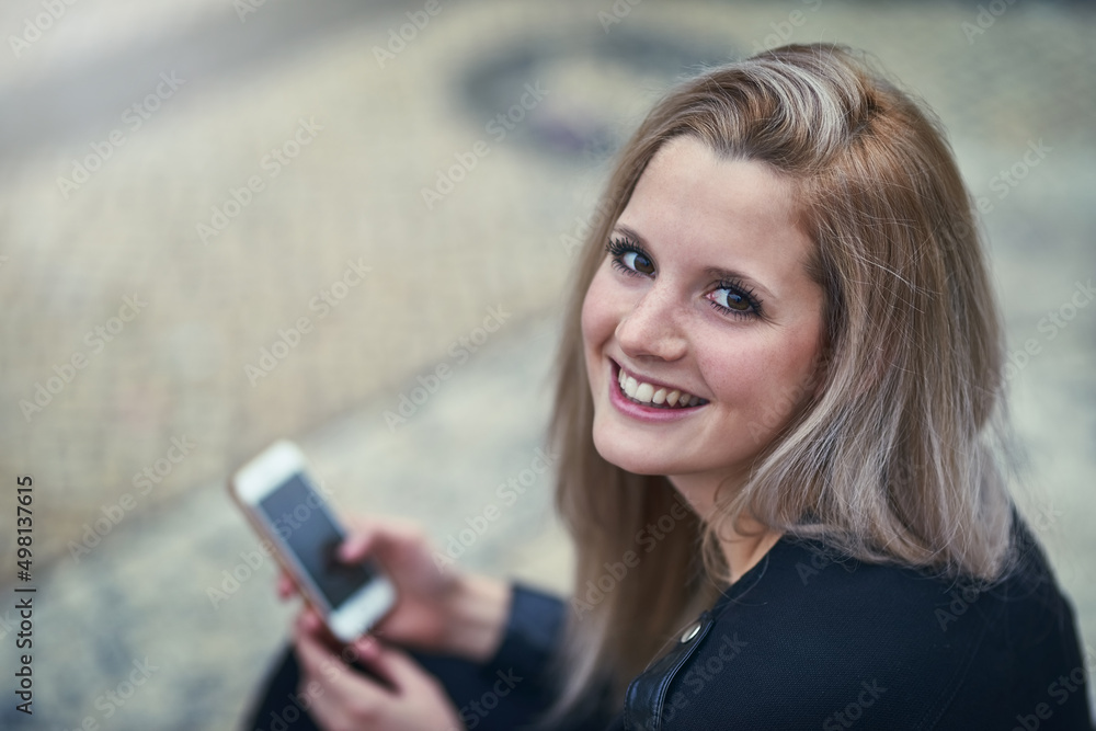 He sent me a heart emoji. Shot of an attractive woman using a mobile phone in the city.