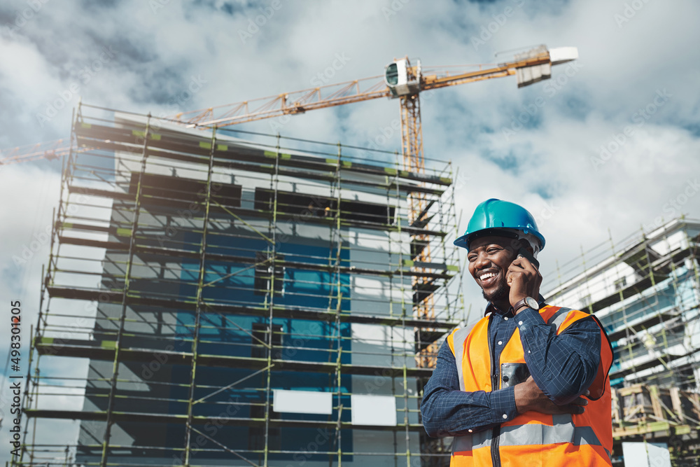 The best building contractor on the block. Shot of a young man using a smartphone while working at a