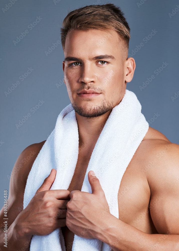 My skin is healthy and protected against dryness. Shot of a handsome young man posing with a towel a