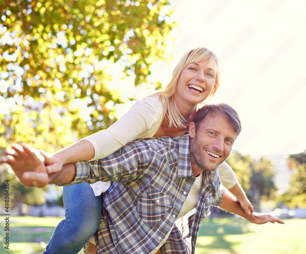 Love makes you act like kids again. Shot of a happy man piggybacking his wife.