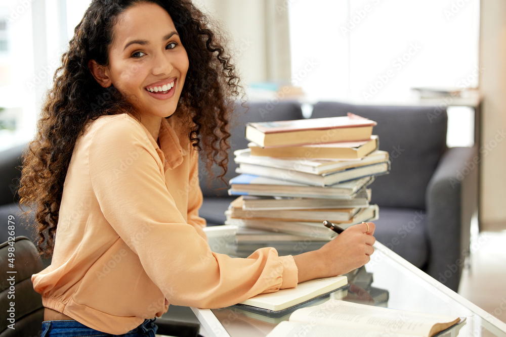 Its never too late to learn. Shot of a beautiful young woman studying from home.