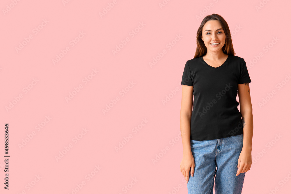 Young woman in blank t-shirt on color background