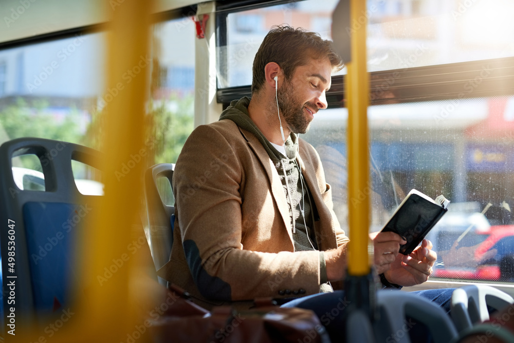 Checking out the best tourist spots. Cropped shot of a handsome young man reading a book during his 