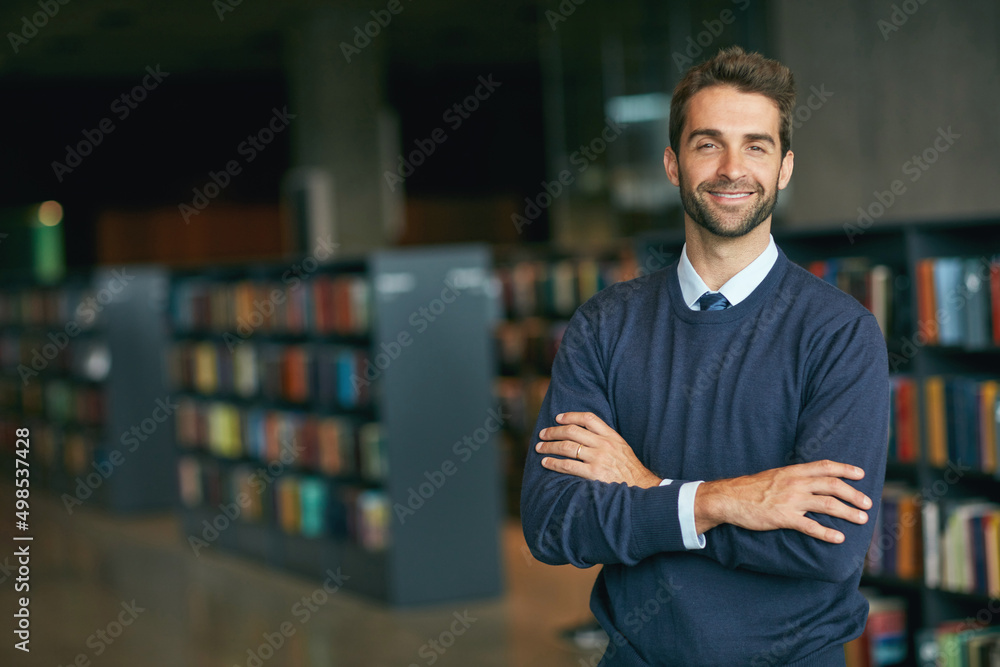 Knowledge really is power. Cropped portrait of a handsome young businessman standing with his arms c