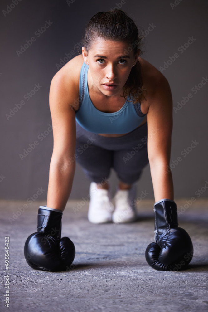 Do you choose the pain of discipline or regret. Portrait of a young woman exercising while wearing b