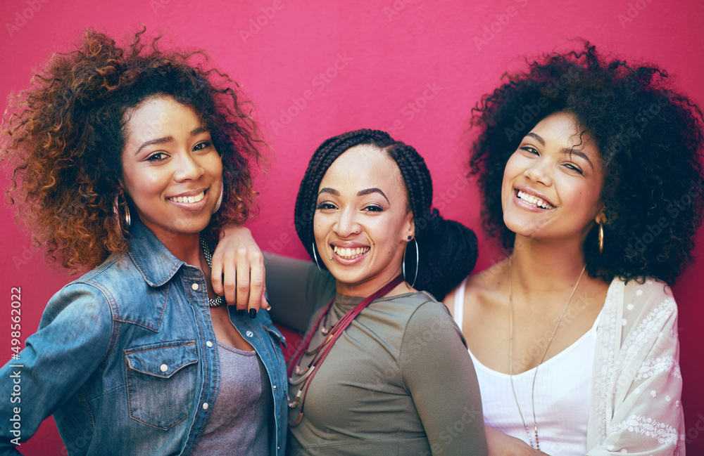 Best friends More like sisters. Portrait of a group of female friends posing against a pink backgrou