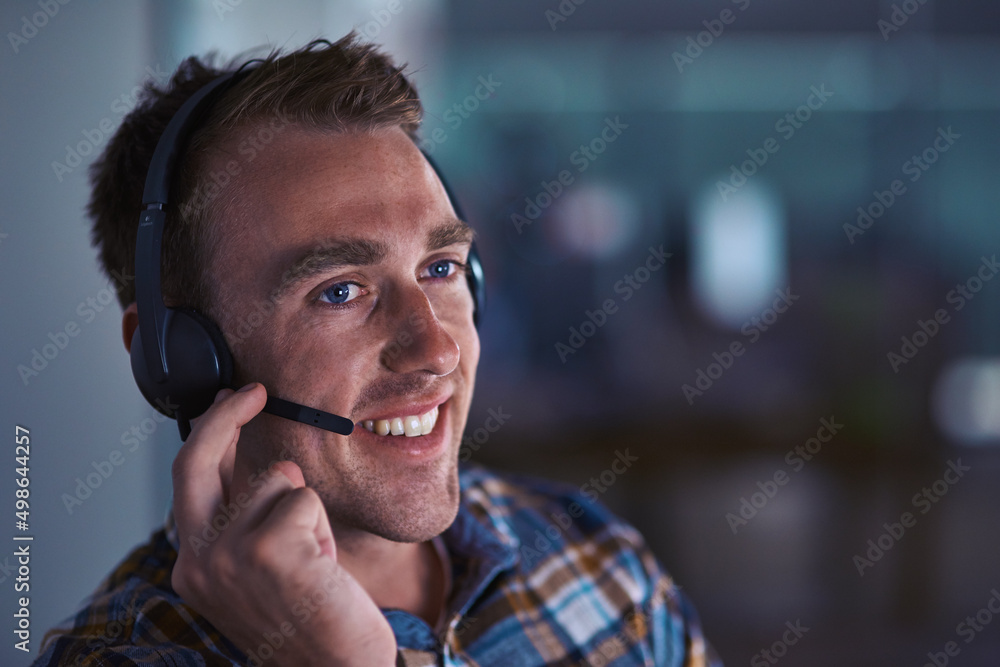 Service with a smile. Shot of a happy customer service agent wearing a headset while sitting in the 