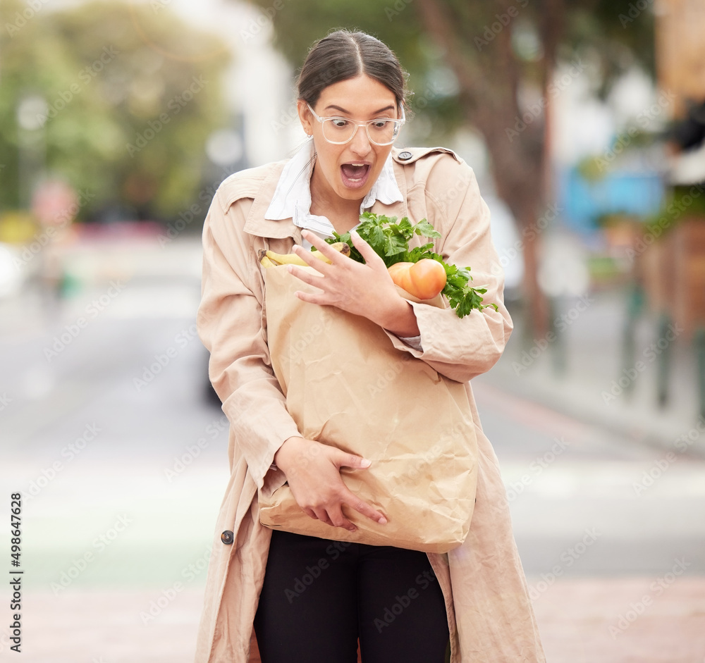 These paper bags arent always the best option. Shot of a beautiful young woman trying to hold keep h