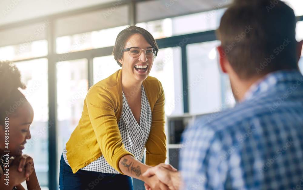 Were so glad that youll be joining our team. Cropped shot of businesspeople shaking hands in an offi