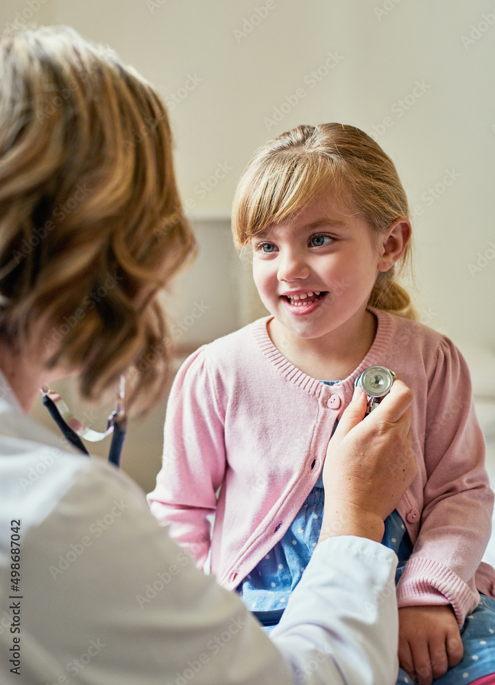 Healthy heart=happy heart. Shot of a doctor examining a little girl with a stethoscope in her consul