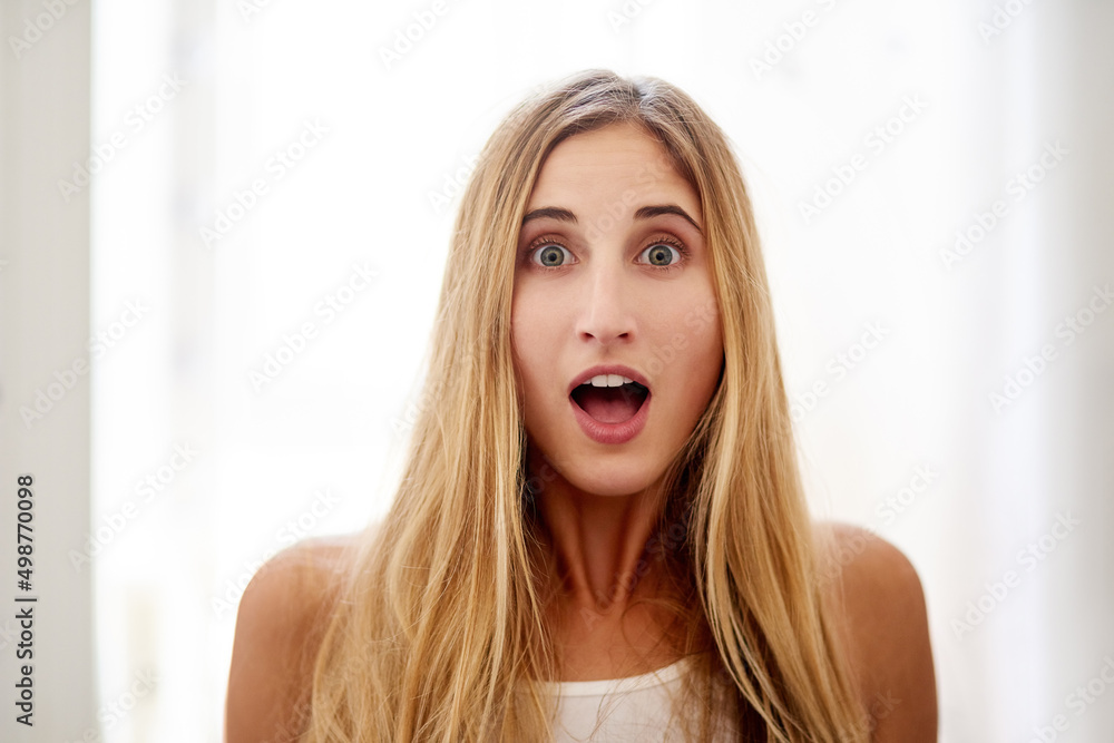 Is it Saturday already. Portrait of a young woman pulling a surprised face at home.