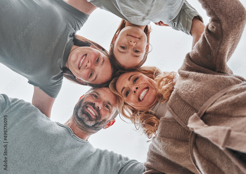 When we have each other, we have everything. Shot of a family of four standing together in a huddle.