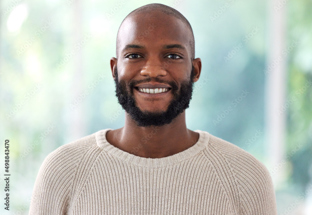 Im always smiling. Shot of a young man smiling at home.