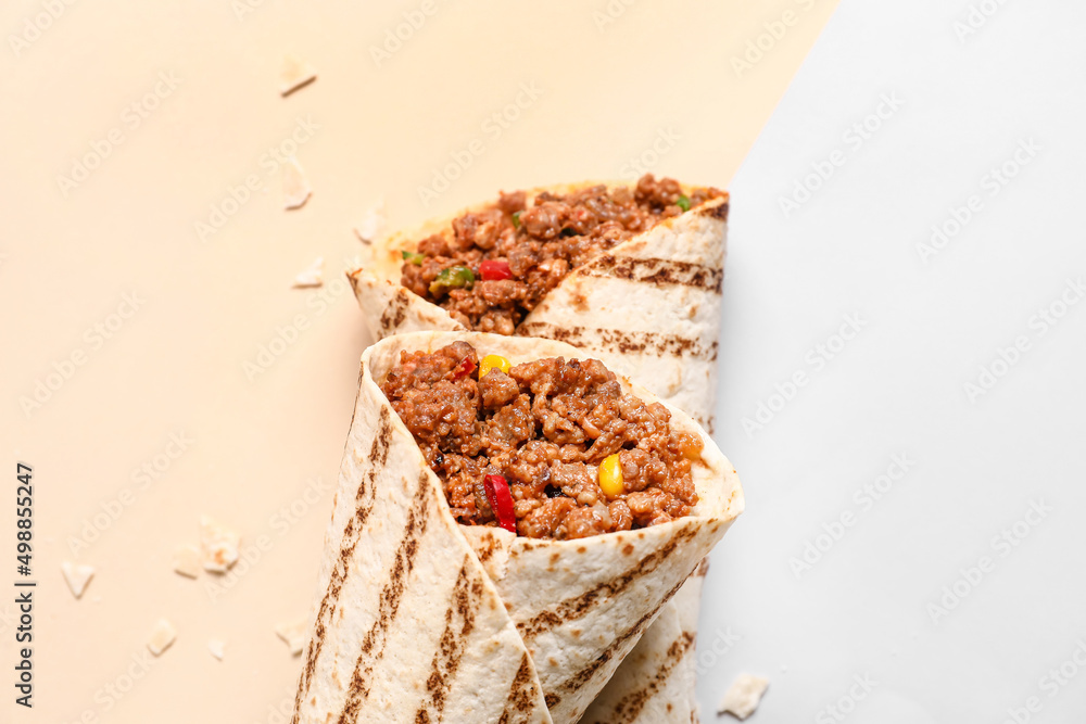 Tasty burritos on color background