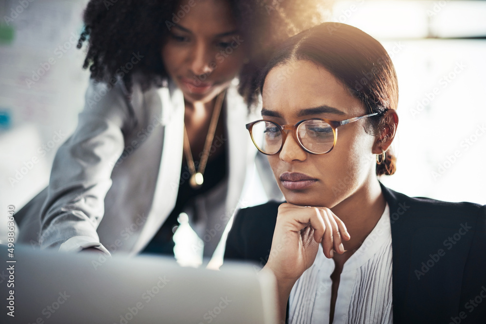 They add careful thought to every move they make. Shot of two businesswomen working together on a la