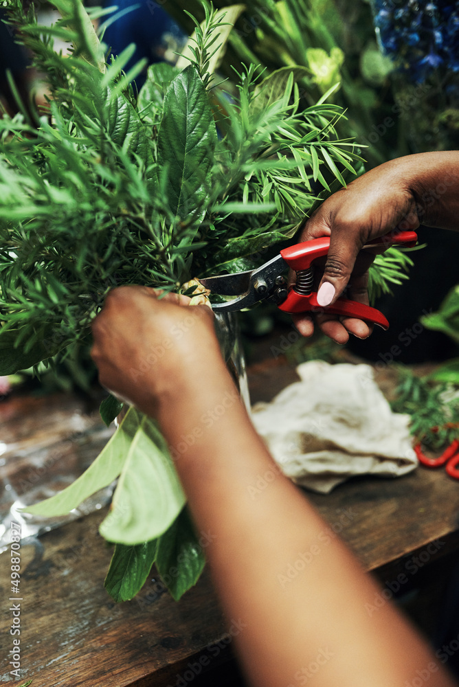 Trimmed up and ready to go. Cropped shot of an unrecognizable florist cutting the stems of a bouquet