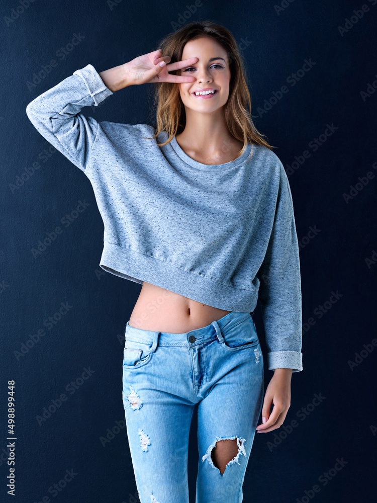 Shes got the look. Studio portrait of a cute teenage girl framing her eye with her fingers posing ag