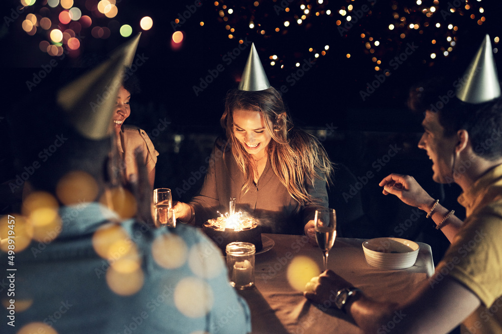 Shes celebrating her birthday with all her close friends. Shot of a group of friends celebrating a b