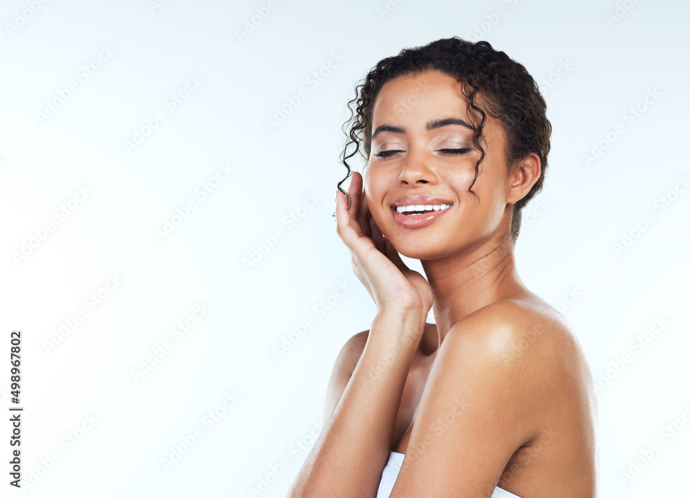 The smile of a woman is the most beautiful curve on her body. Studio shot of an attractive young wom