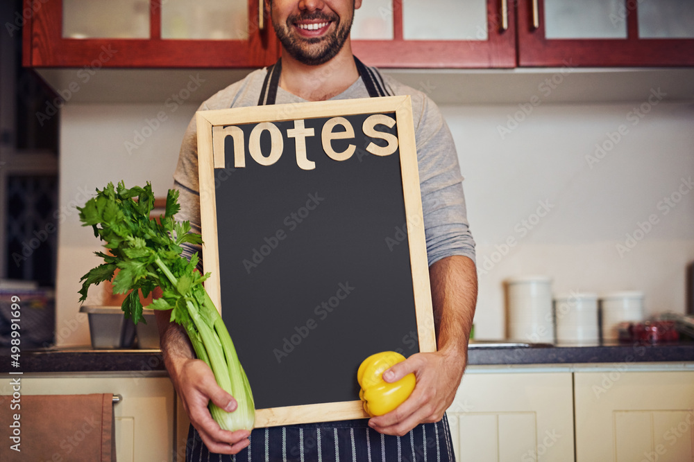 Jot down your shopping list here. Cropped shot of an unidentifiable young man holding a blank chalkb