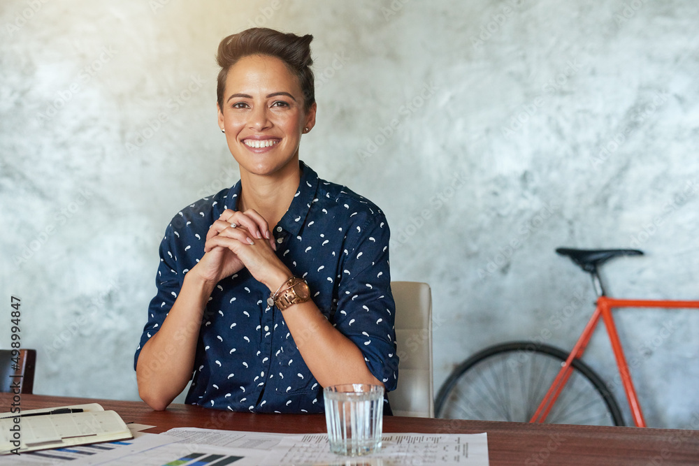 Confidence is key in running a business. Portrait of a creative employee in a modern office.