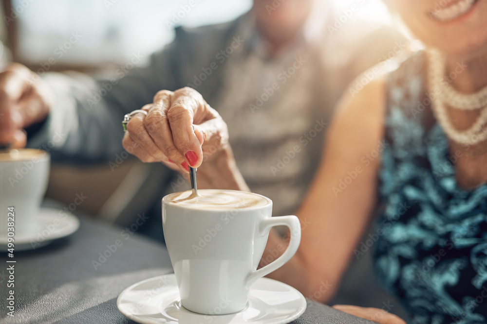 Stirring up something special on their coffee date. Shot of a mature couple spending the day togethe