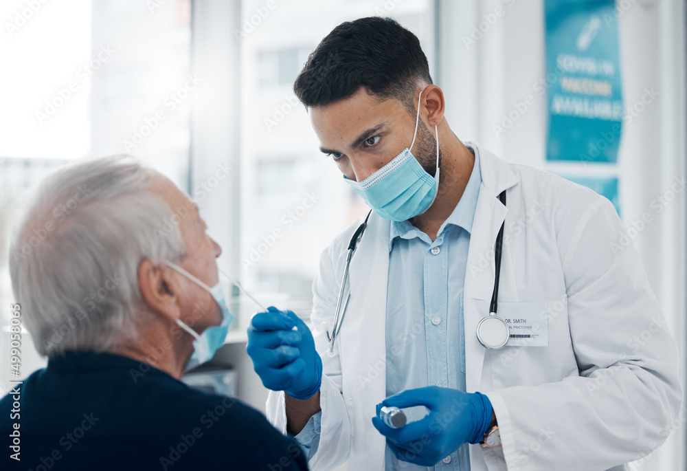 Its gonna be a little uncomfortable. Cropped shot of a handsome young male doctor testing a senior p