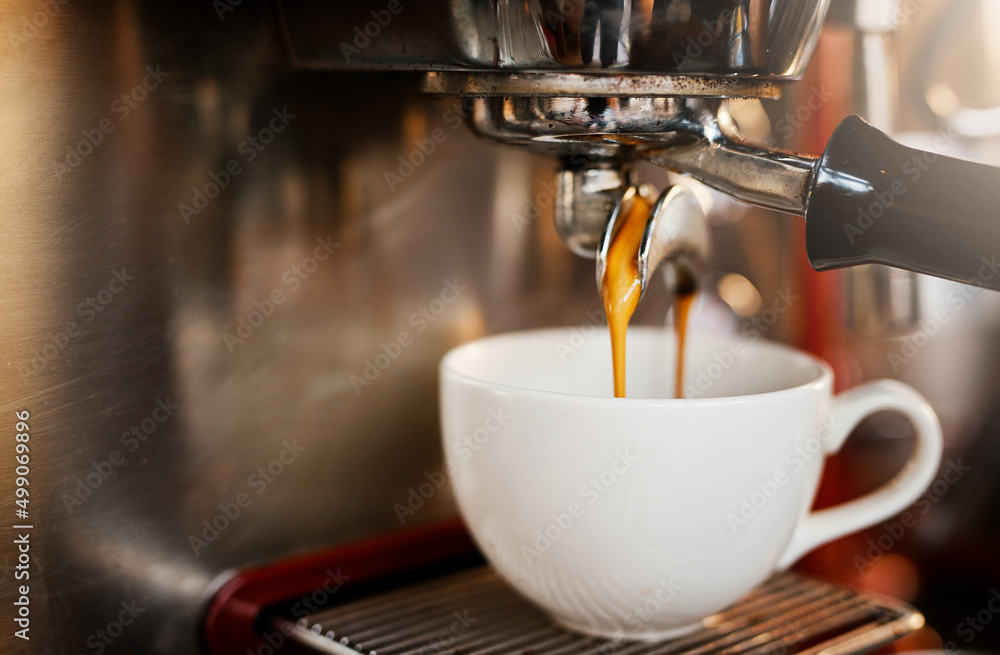 Another one thank you. Closeup shot of an espresso maker pouring coffee into a cup inside of a cafe.